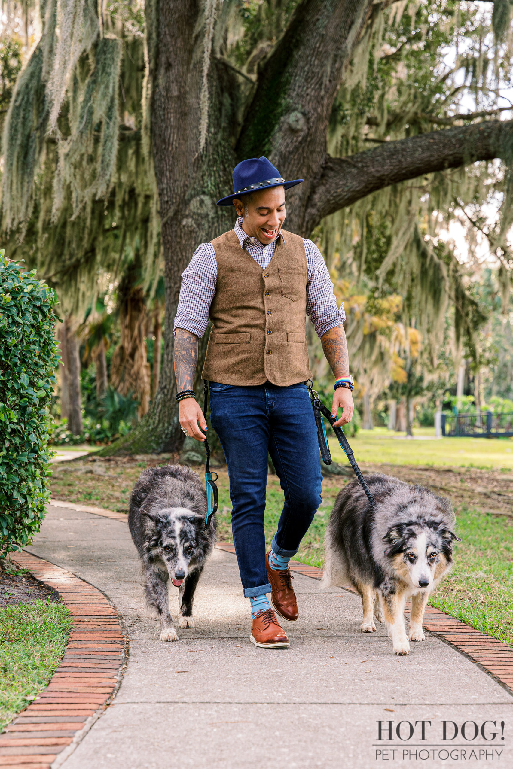 Andres taking a walk with his beloved Border Collies on a scenic trail.