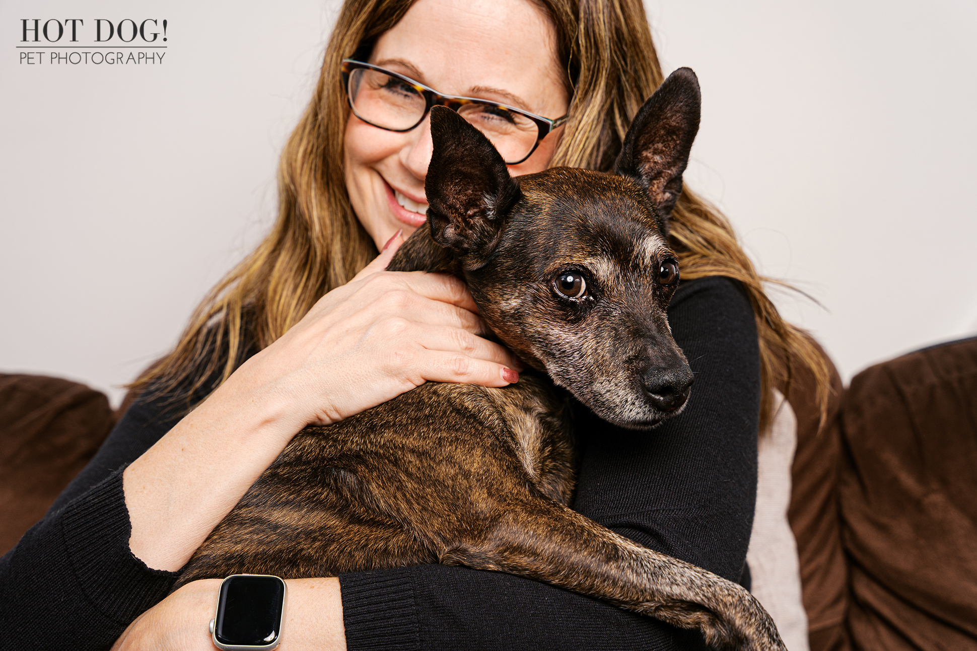 Tracey holding and smiling with her 18-year-old Miniature Pinscher Archer during their Altamonte Springs senior dog photography session.