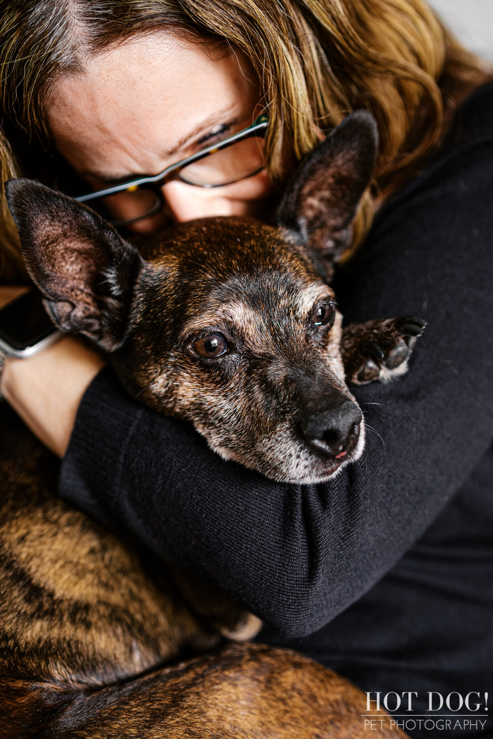 Close-up of Tracey hugging Archer, capturing a quiet, emotional moment during their Cherished Companion session at home.