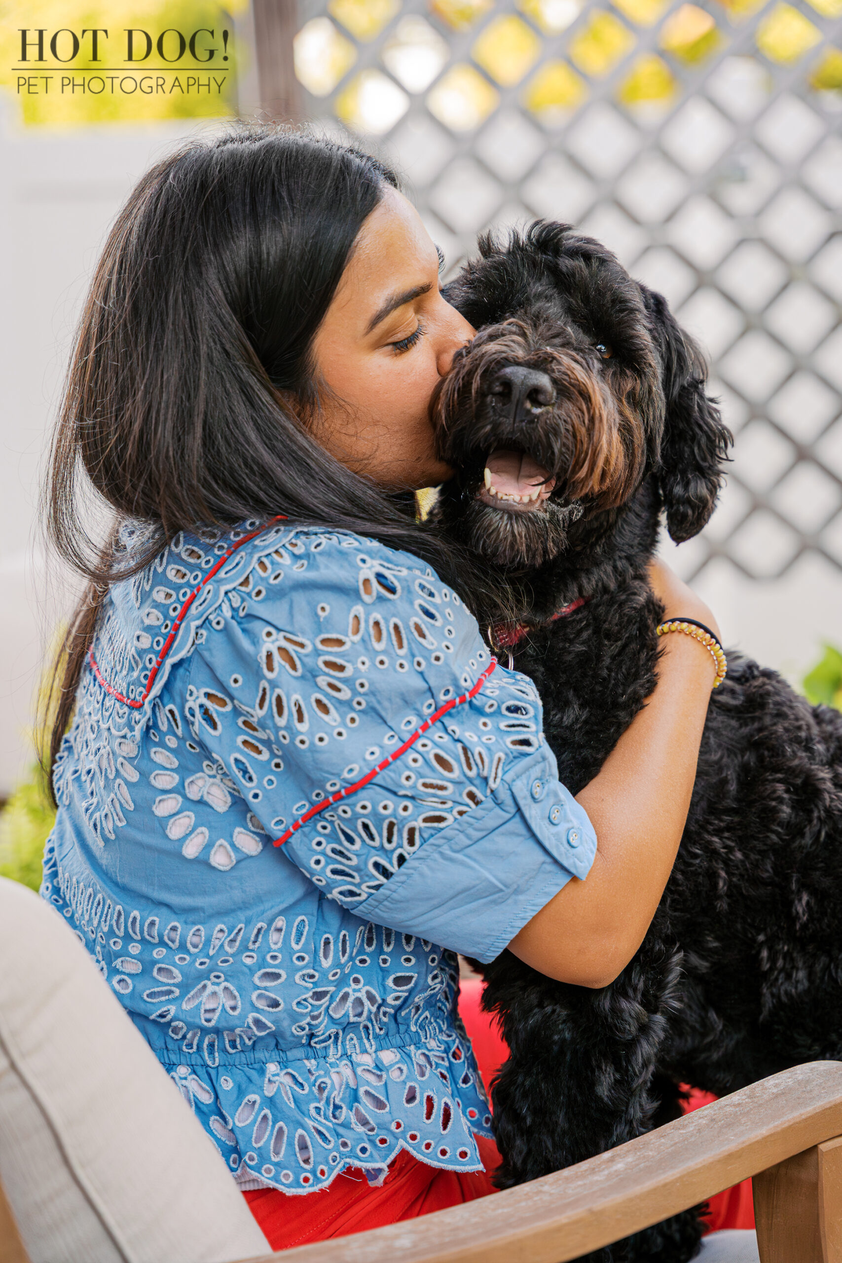 Banjo receives a loving kiss from his mom, Selavi, as she hugs him during their cozy at-home Winter Park photo session.