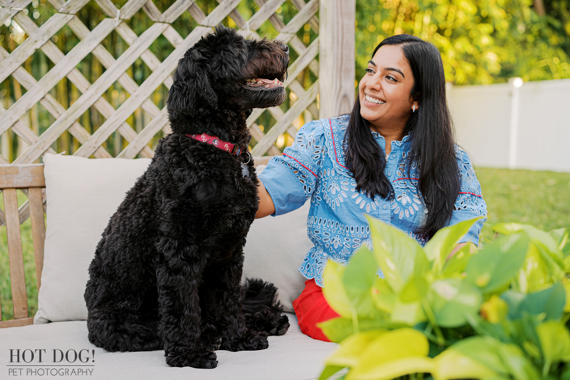 A woman and her Portuguese water dog enjoy their backyard during an in-home pet photo session in Orlando, Florida.
