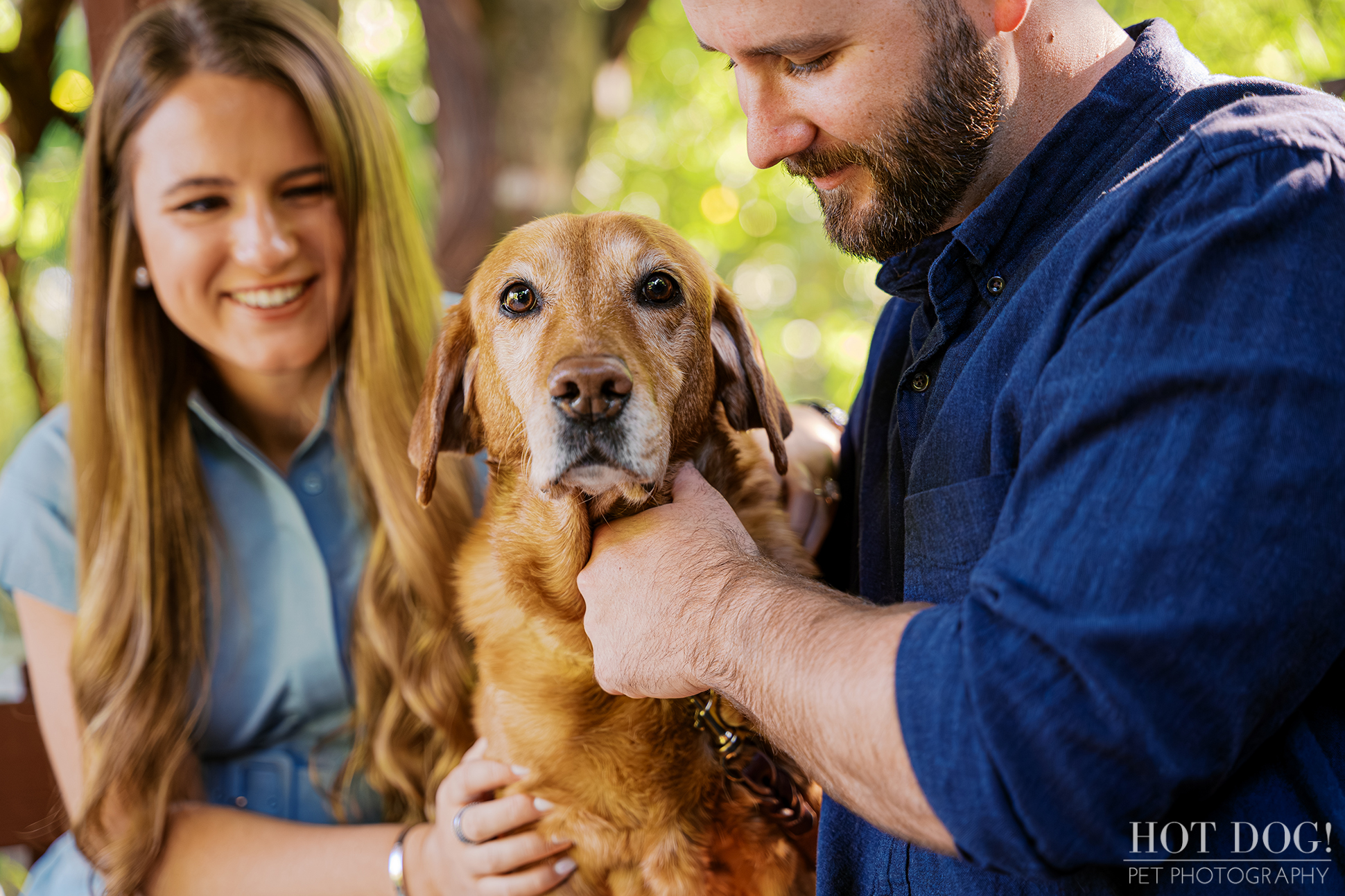 Dixie the senior red Labrador Retriever sits between Chloe and Bryson during their Cherished Companion photography session at Kanapaha Botanical Gardens.