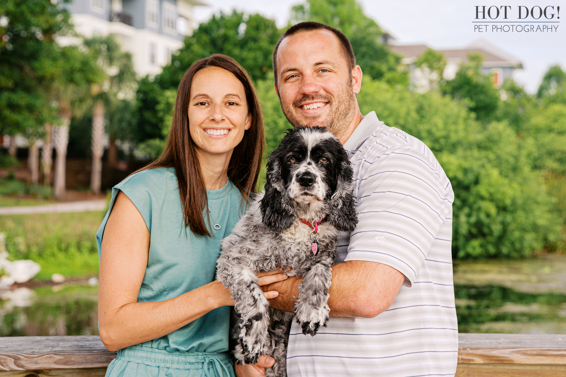 Tiffany and Rob holding their senior cocker spaniel Ella during a family pet photography session at Harbor Park in Baldwin Park.