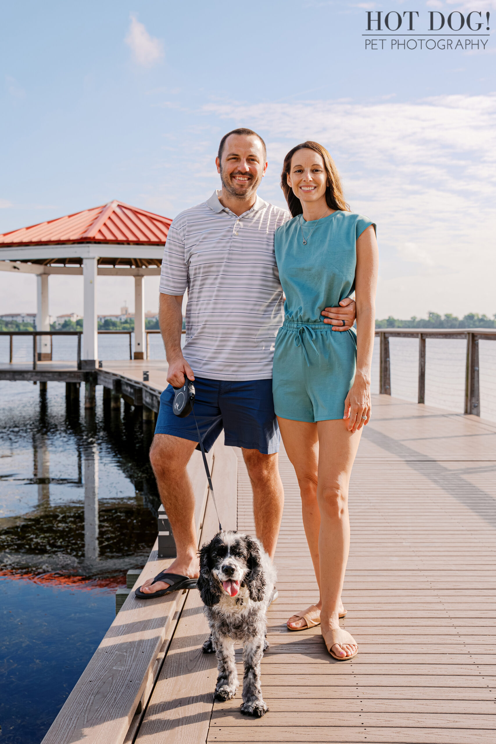 Tiffany and Rob posing with their senior cocker spaniel Ella on the boardwalk at Harbor Park in Baldwin Park.