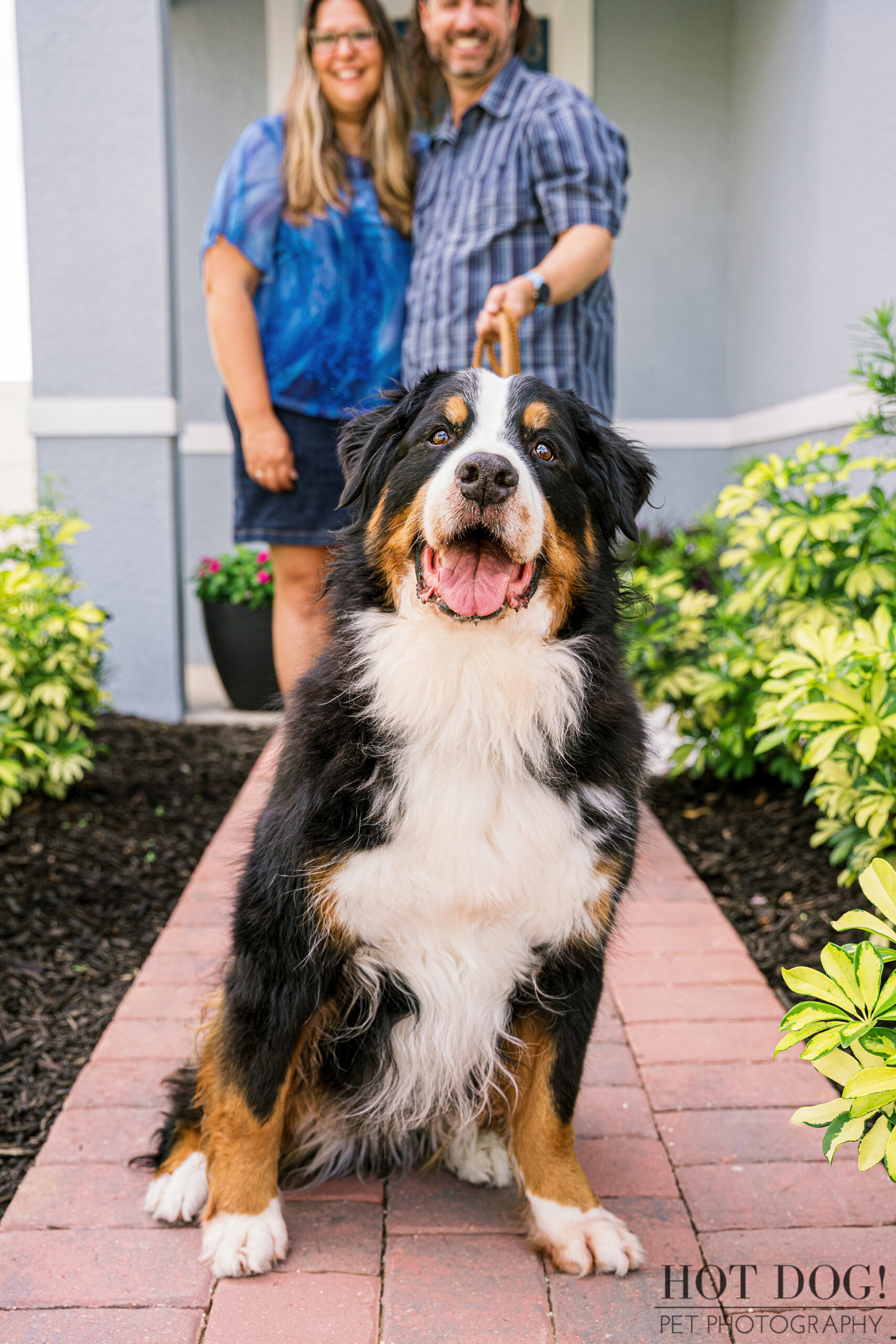 Flynn sitting proudly in front of his parents on a garden walkway.