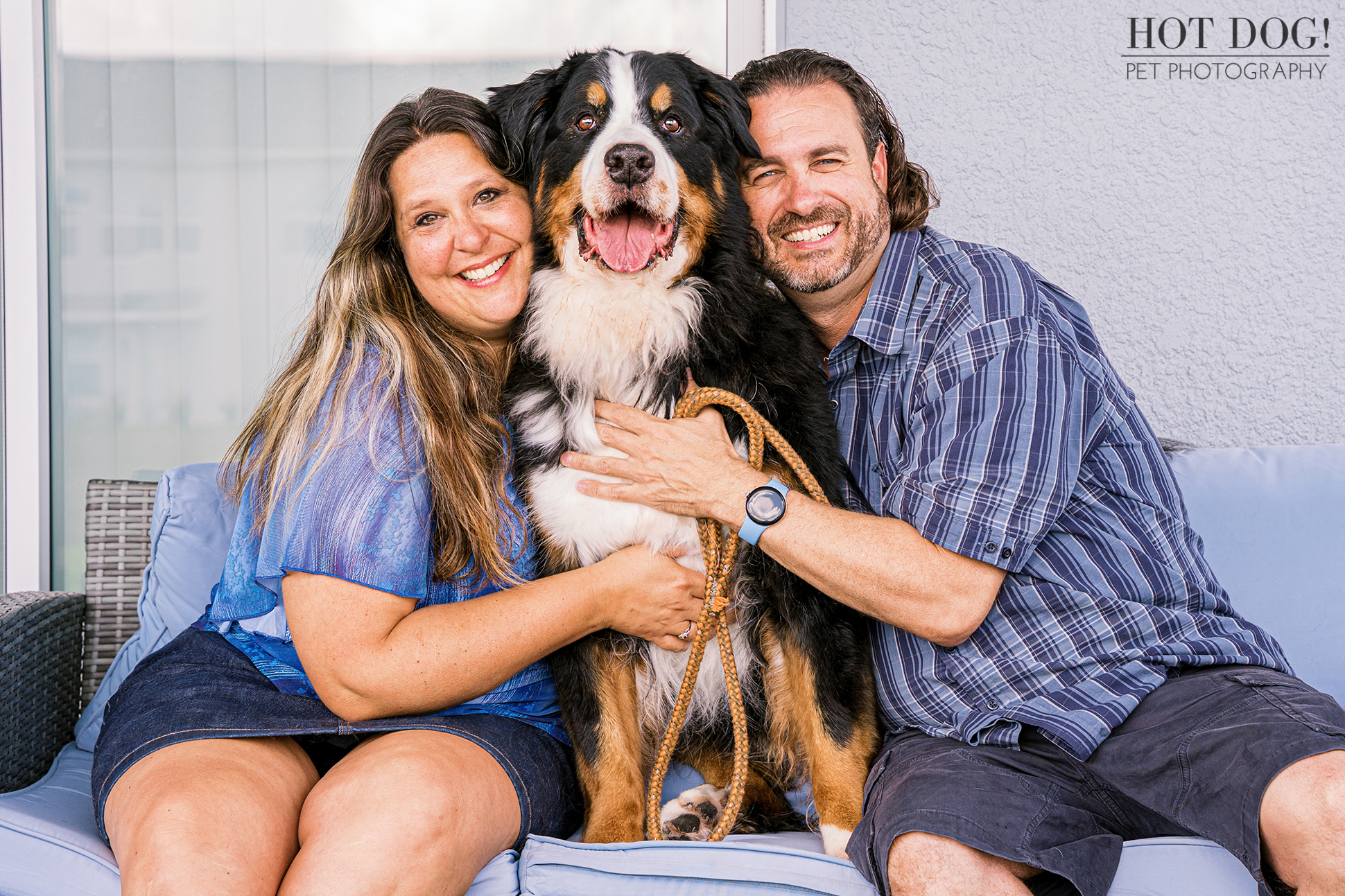 The family sitting together with Flynn on their patio, smiling at the camera.