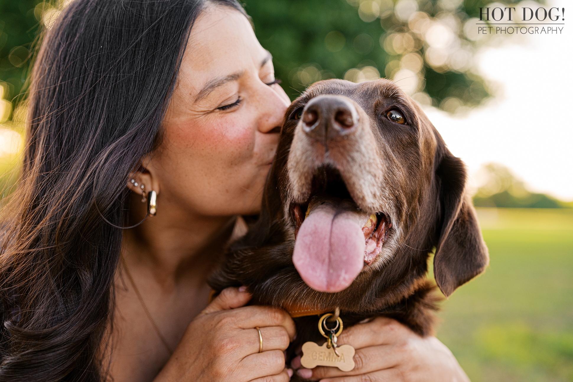 Anne hugs and kisses Gemma, her senior brown Lab mix, during a heartfelt family dog photography session in Orlando.