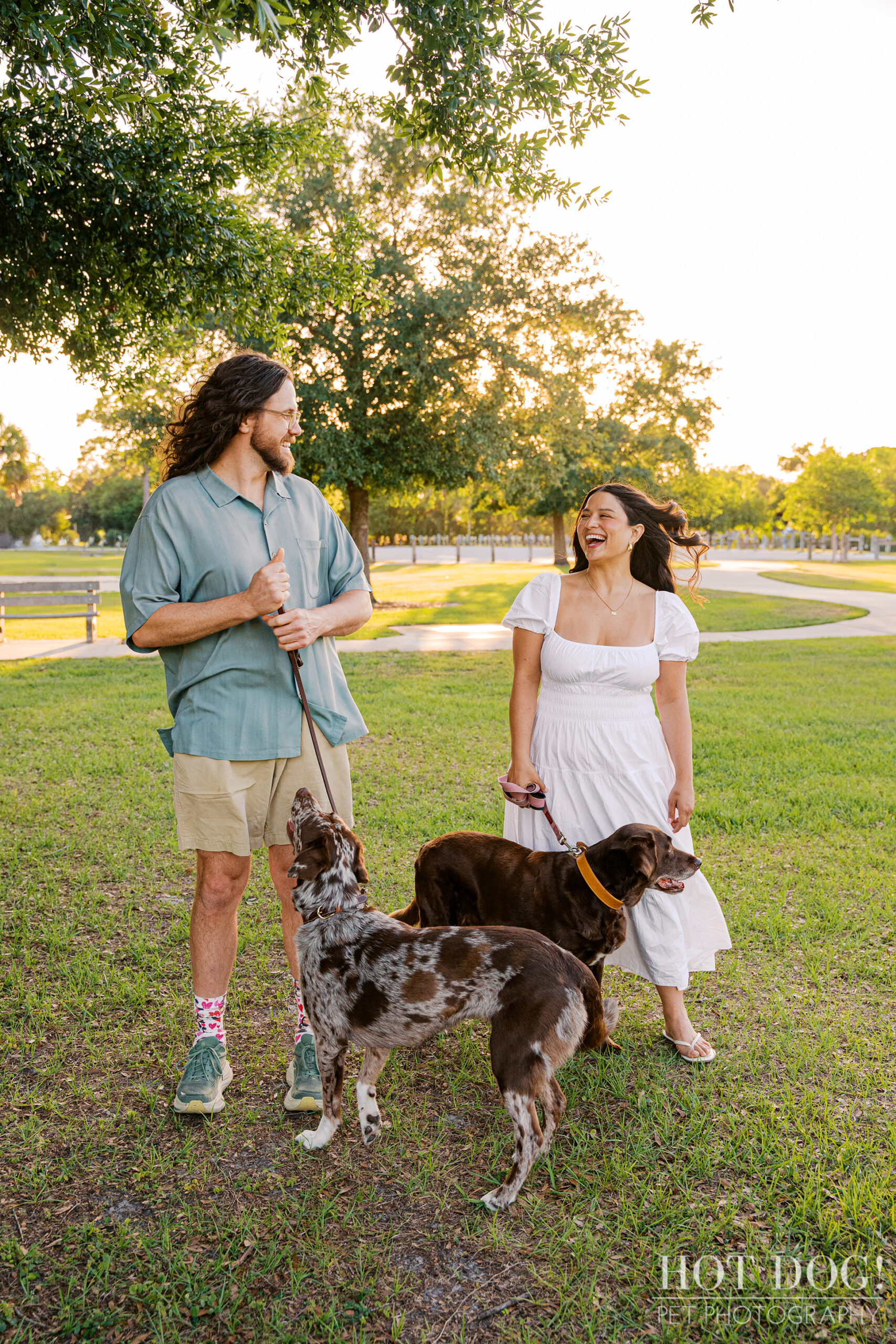 Anne and Jared share a laugh while walking Gemma and Ellie beneath the oak trees at Lake Druid Park in Orlando.