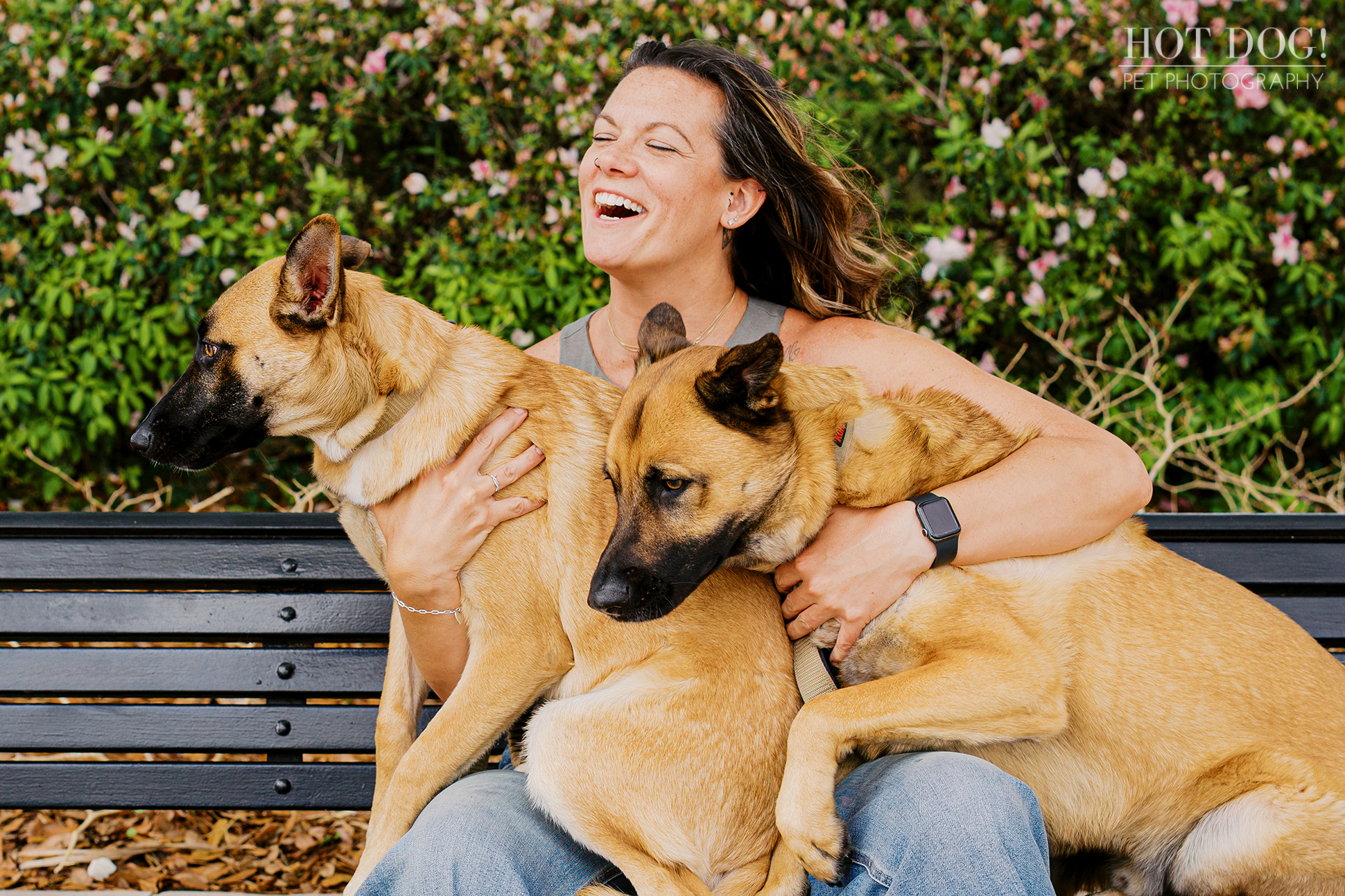 Krystle holding Maverick and Goose together on her lap on a park bench, capturing their affectionate bond during a Baldwin Park session.