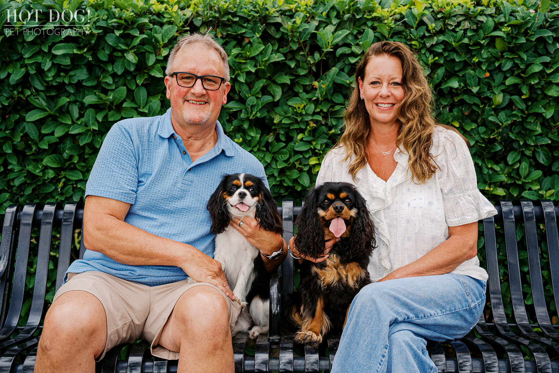 Tonia and James sitting with Cavalier King Charles Spaniels Jerzee and Jazmyn during a relaxed Central Florida family pet photography session.