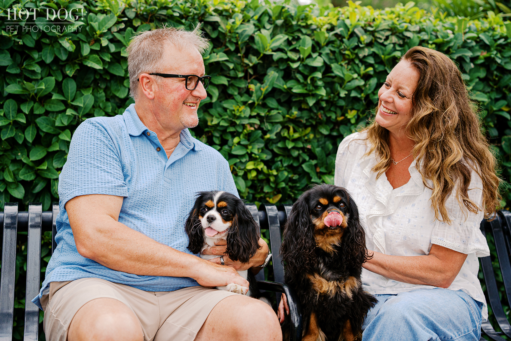 Tonia and James sharing a smile with Cavalier King Charles Spaniels Jerzee and Jazmyn during their Florida vacation photo session.