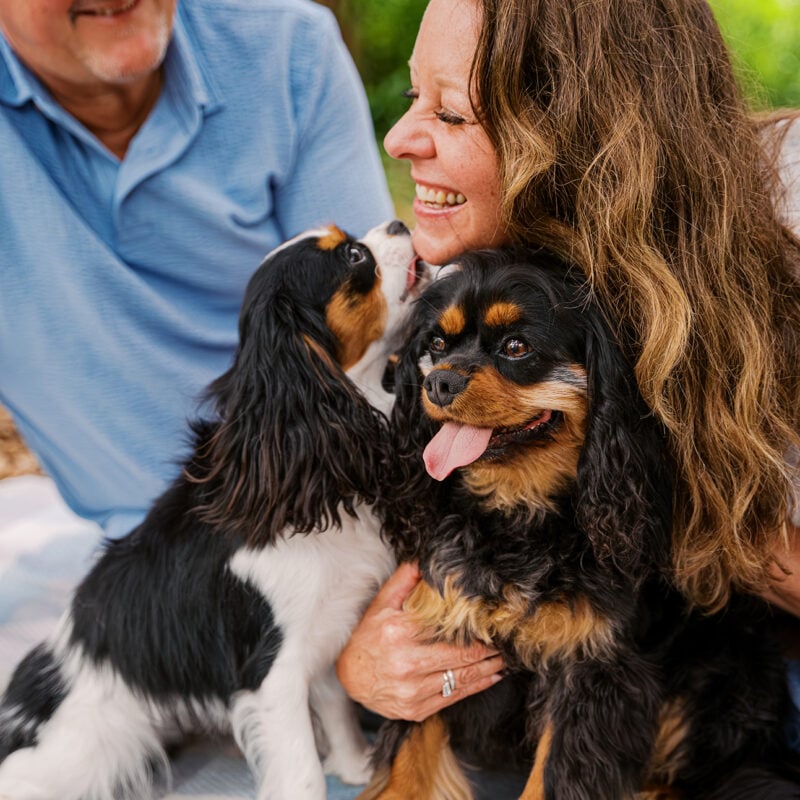 Jerzee giving Tonia a kiss while Jazmyn sits beside them during a playful Central Florida pet photography session.