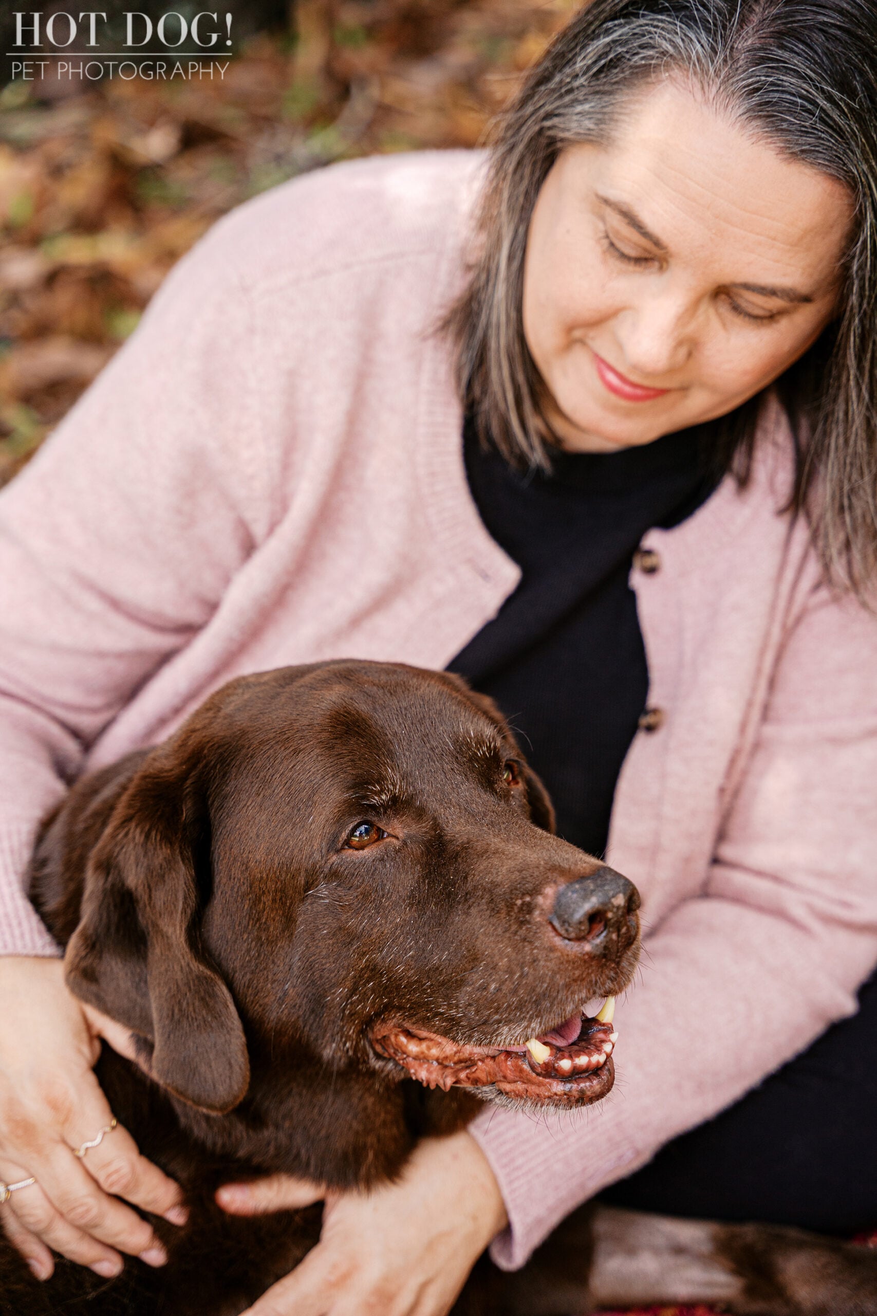 A tender moment between Jennifer and her nine-year-old chocolate Lab, Kona, during a Cherished Companion pet photography session celebrating their special bond.