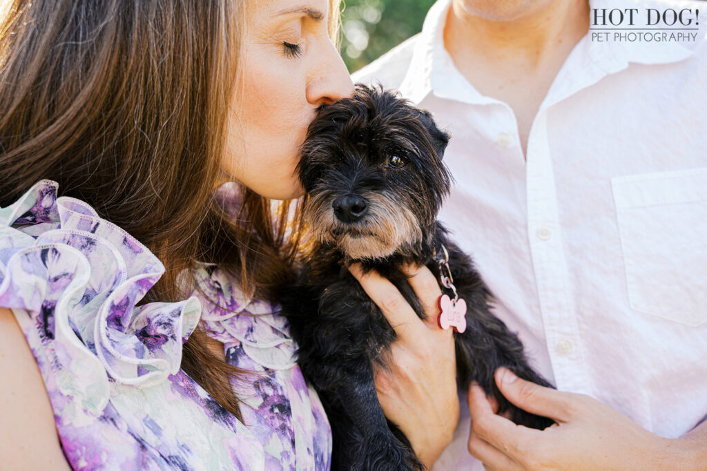 Rae kissing Luna on the head while holding her close.