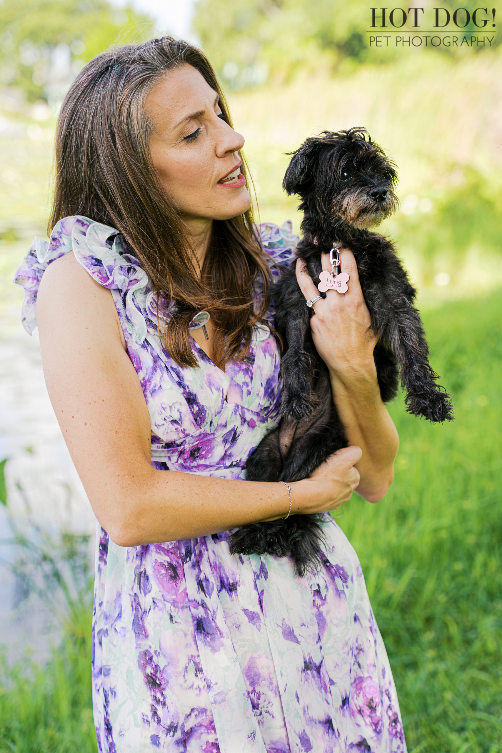 Rae looking lovingly at Luna near a peaceful lake.
