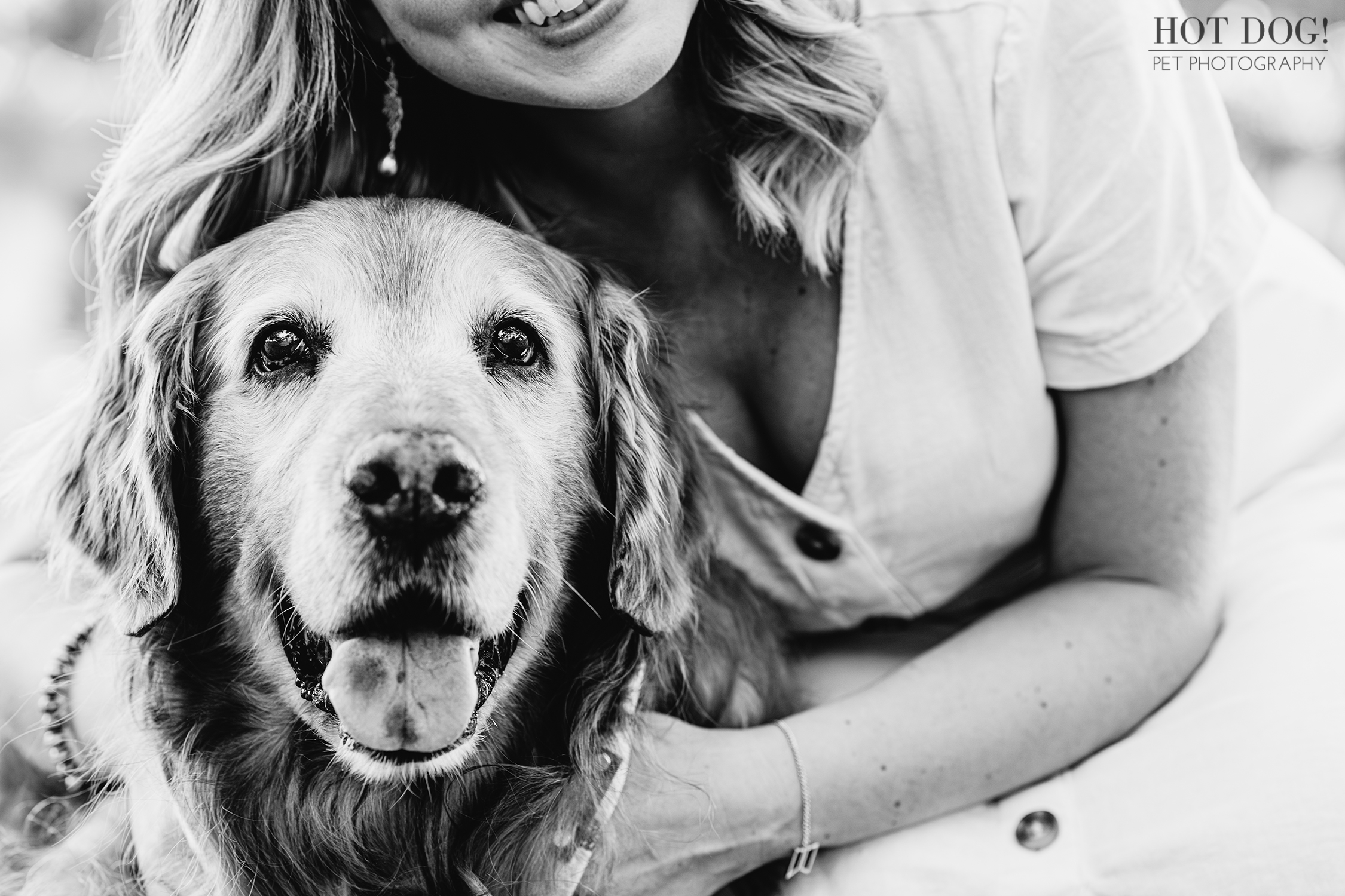 Golden Years Glow: Senior golden retriever Osho and his mom snuggle in Celebration Town Square. (Photo by Hot Dog! Pet Photography)