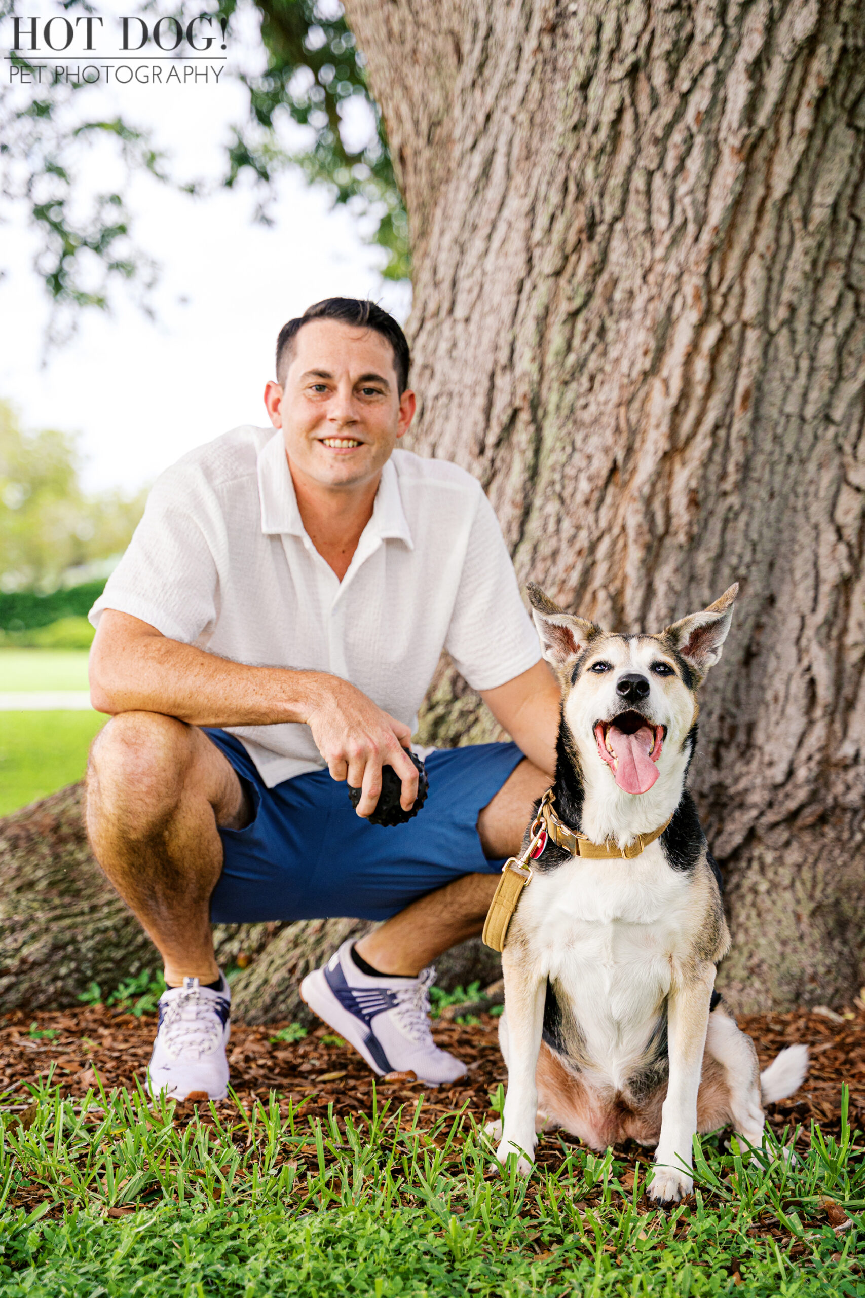 Brandon kneeling beside Emmy, both smiling during their dog photo session.