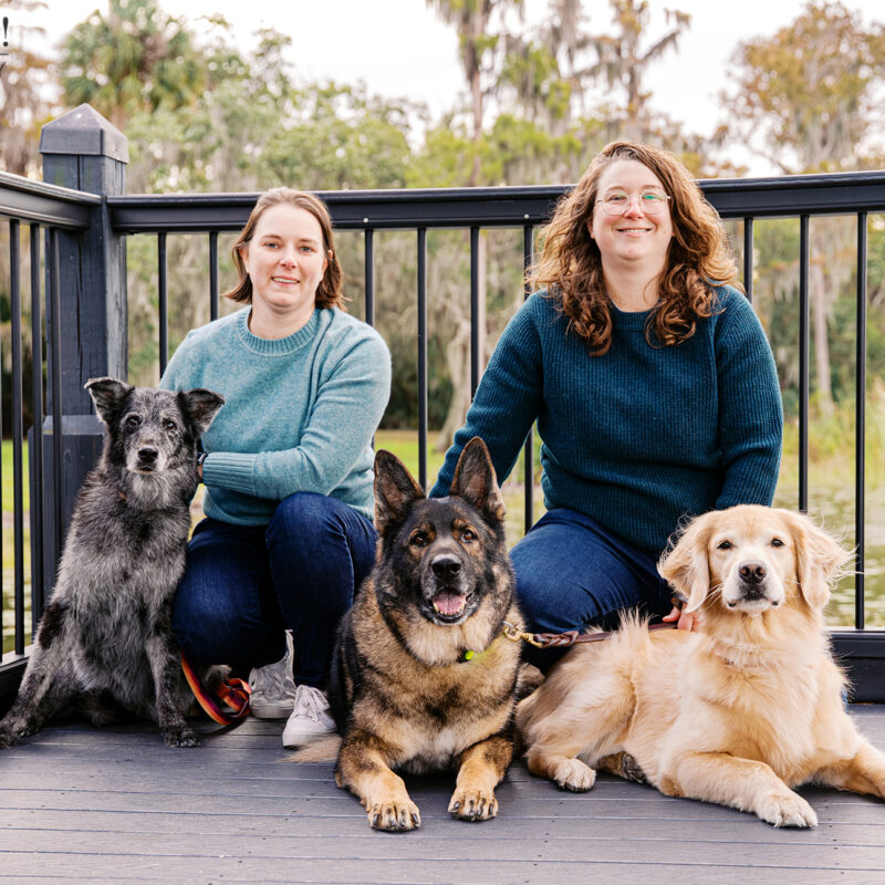 Aimee and Lindsay with Sadie, Appa, and Korra on a dock at Cypress Grove Park in Orlando, Florida.